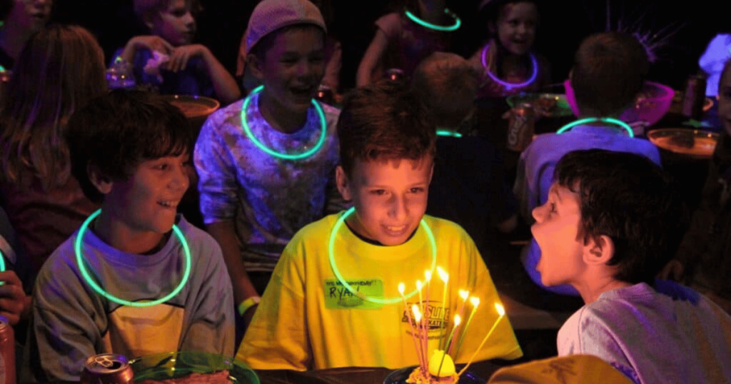 Kids celebrating a birthday together with smiles and excitement