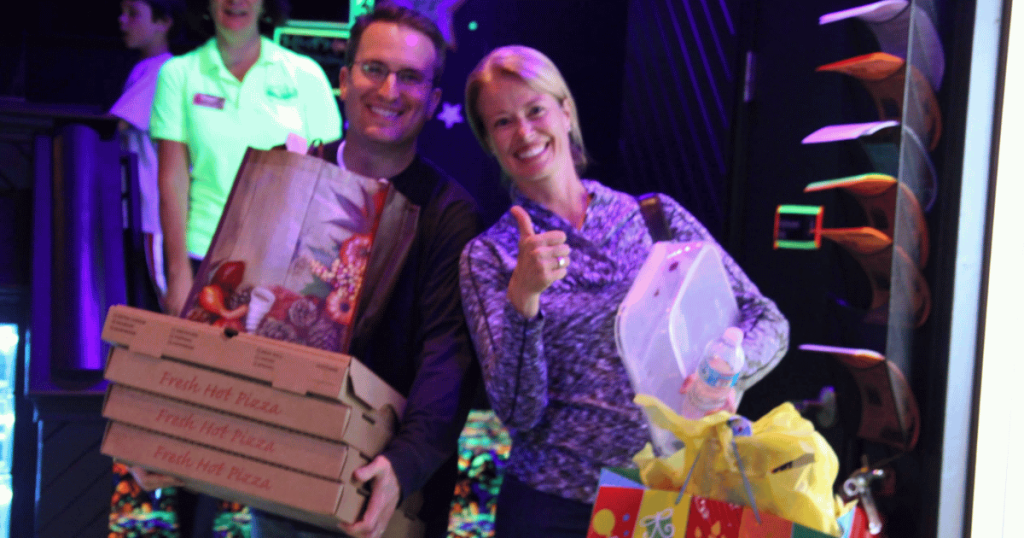 Parents relaxing while kids enjoy a supervised indoor birthday party