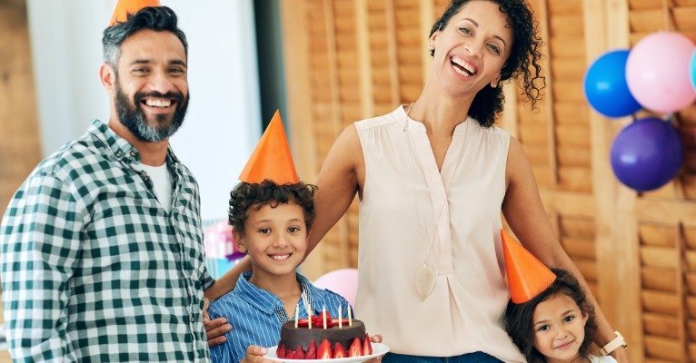 Parents socializing while kids enjoy a birthday party
