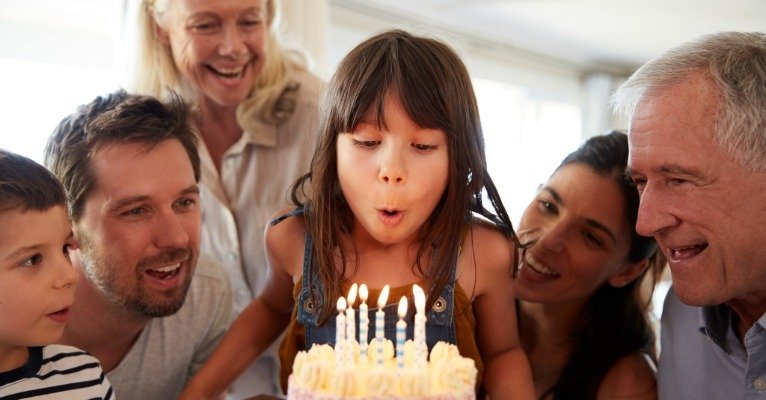 Parents smiling while kids enjoy a stress-free indoor birthday party in Pittsburgh