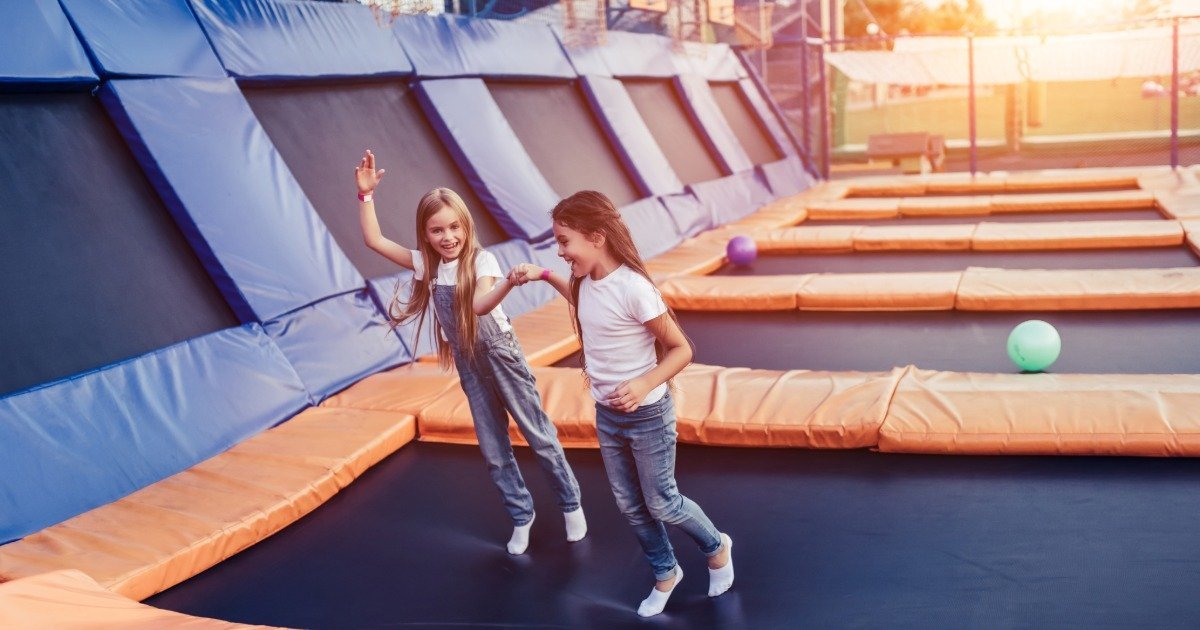 Kids jumping on trampolines indoors