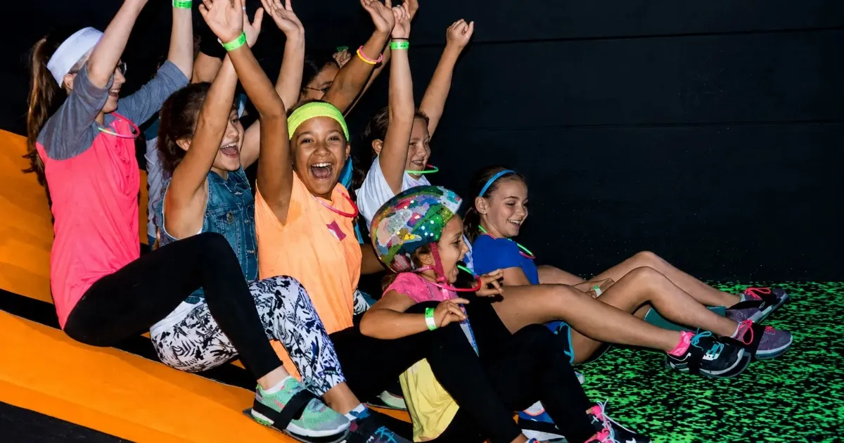 Kids carpet skating under blacklight at an indoor skatepark in Pittsburgh's North Hills