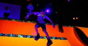 Kid skating down a bright orange ramp at Fun Slides in Pittsburgh